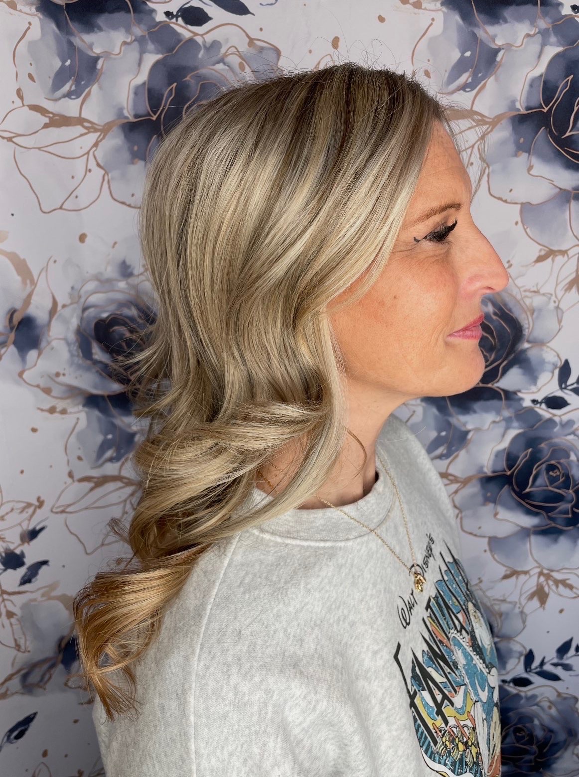 Profile view of the same dimensional blonde hair with a bright face-framing section.