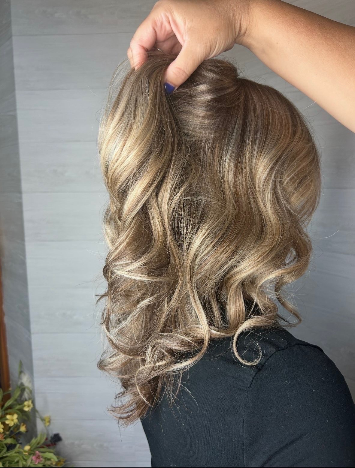 Detail view of the same brunette hair lifted to show blended dimension underneath.