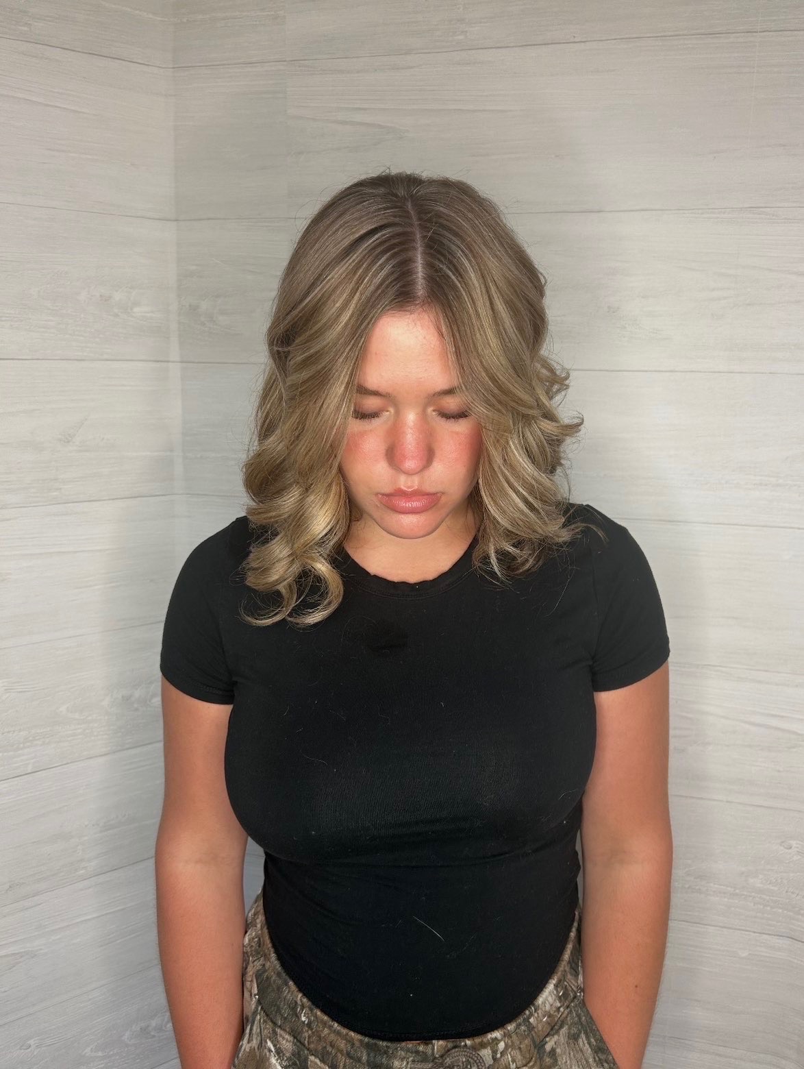 Front view of the same brunette finish with a soft center part and face-framing pieces.